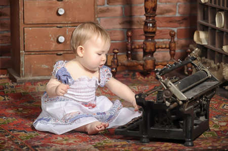 little girl with a typewriterの写真素材