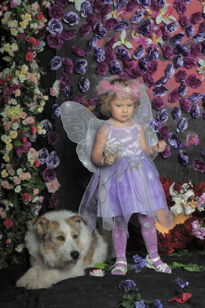 girl with butterfly wings and a dogの写真素材