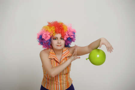 Girl with balloons in a colored wigの写真素材