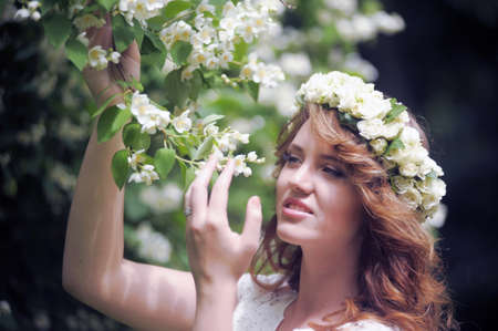Beautiful girl near a flowering tree の写真素材