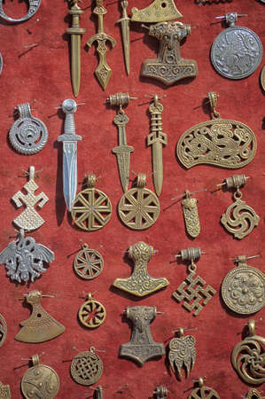 Ancient pagan decoration on a red clothの写真素材