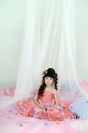 Little, cute girl wearing pink dress.の写真素材