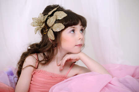 Little, cute girl wearing pink dress.の写真素材