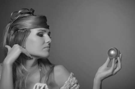 blonde with beautiful hairstyle and christmas balls in his handsの写真素材