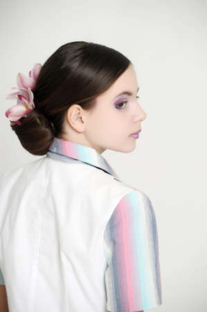 girl with beautiful hairstyle with orchid in her hairの写真素材