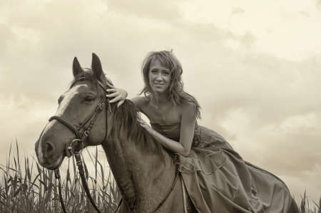 young beautiful woman with a horse, retro photoの写真素材