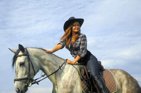 girl in a cowboy hat on a horse
