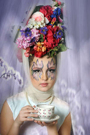 Girl with flowers on her head during a tea party