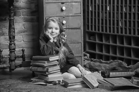 girl with a book in the old libraryの写真素材