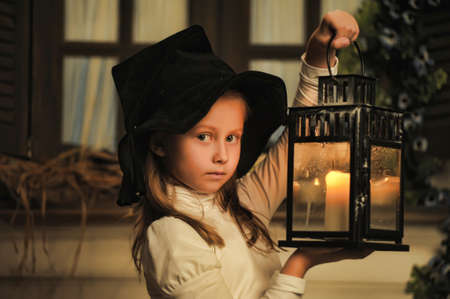 Girl with lanterns in witch hat の写真素材