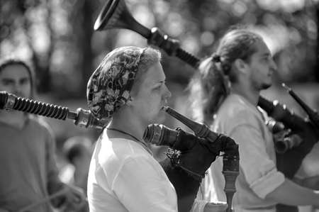 Unidentified musicians in medieval clothes play ancient musical instruments at festival Iron hailstones のeditorial素材