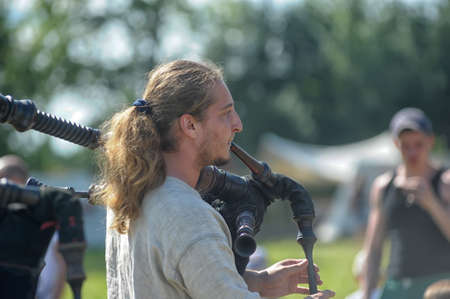 Unidentified musicians in medieval clothes play ancient musical instruments at festival Iron hailstones のeditorial素材