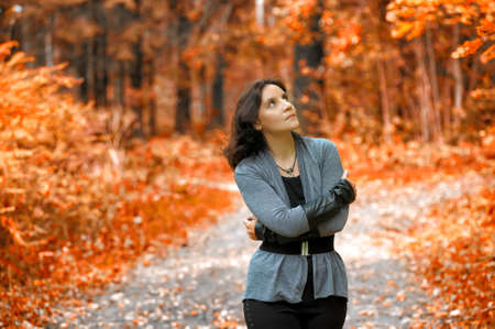 slim girl in a gray autumn parkの写真素材