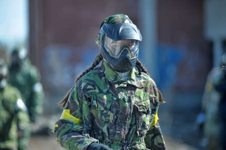 Girl playing paintball in camouflage.のeditorial素材