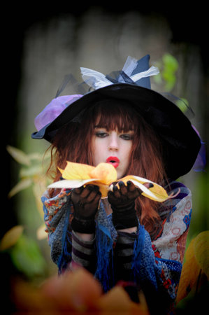 woman witch in hat in the woods
