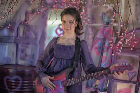 Beautiful young girl with electric guitarの写真素材