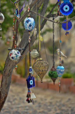 Evil eye charms hang from a bare tree in Cappadocia, Turkey.の写真素材