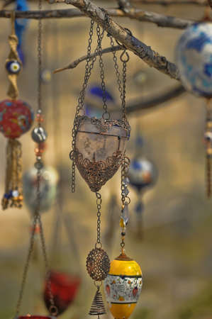 Evil eye charms hang from a bare tree in Cappadocia, Turkey.の写真素材