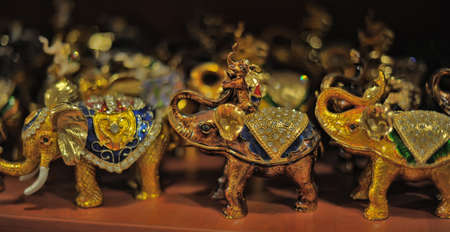 Souvenir elephants standing in a row on a shelf in store for tourists.の写真素材