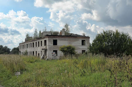 Abandoned brick two-story building - military barracks, Russia.