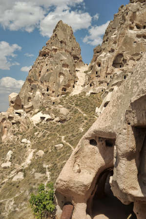 N ancient times people carved out homes in the fairy chimney rock formations in Cappadocia, Turkey. The houses are a popular tourist attraction for people on vacation or holiday.の写真素材