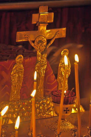 Kanun - remembrance table with candles and crucifix in church.