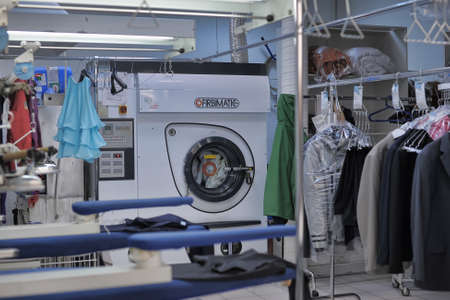 Reception point of dry cleaning, lot of clean clothes in pack. Auchan, St. Petersburg, Russia.のeditorial素材