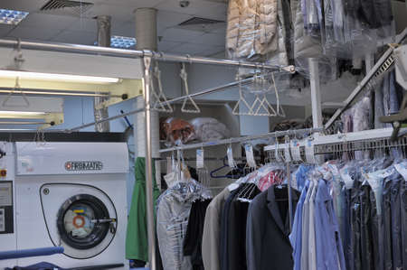 Reception point of dry cleaning, lot of clean clothes in pack. Auchan, St. Petersburg, Russia.のeditorial素材
