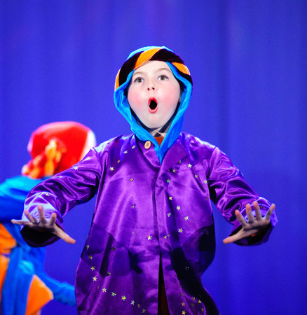 Little children dancing with old oriental costumes on stage