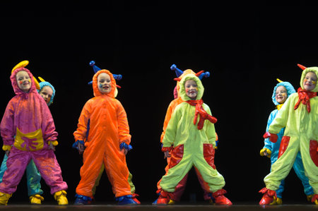Children in funny colored overalls aliens dancing on stage, the performance of children's dancing collectives, St. Petersburg, Russia. Photo Taken On: May 26Th, 2012のeditorial素材