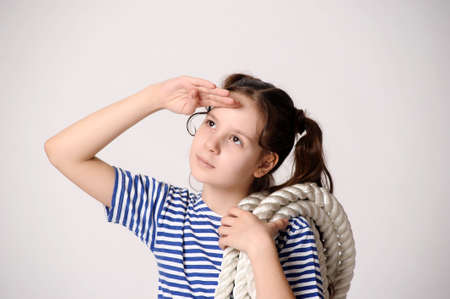 Girl in a striped T-shirt and breeches with rope.の写真素材
