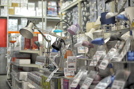 Home and office lighting products are displayed on the shelves in a hardware store.のeditorial素材