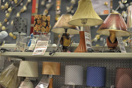 Home and office lighting products are displayed on the shelves in a hardware store.のeditorial素材