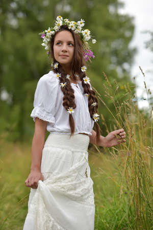 Girl with braids and daisies in her hair.の写真素材