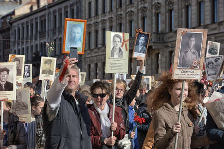 The action Immortal regiment on Victory parade. People go with portraits of their relatives, who participated in the Second World War. The celebration of 70 anniversary of Victory in the Great Patriotic War.のeditorial素材
