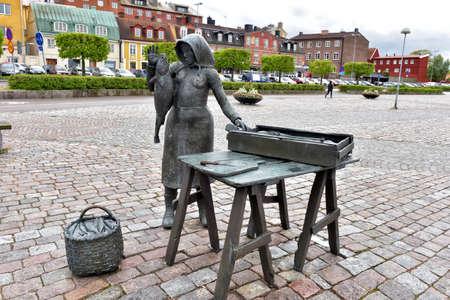 Statue of woman selling fish in a square in the city of Karlskrona in Sweden.のeditorial素材