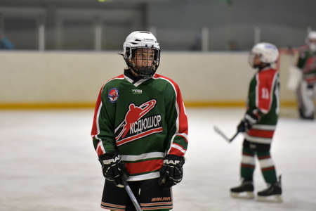 Children playing hockey on a city tournament Murmansk, Russia.のeditorial素材