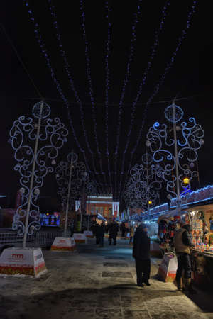 People at the Christmas Fair on the Pionerskaya square. Visitors can buy food and souvenirs from various regions of Russia.のeditorial素材