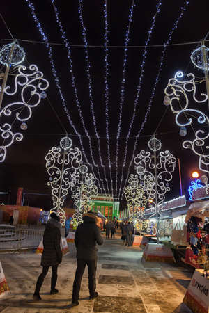 People at the Christmas Fair on the Pionerskaya square. Visitors can buy food and souvenirs from various regions of Russia.のeditorial素材