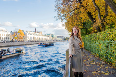 Beautiful brunette woman in autumn beige coat.の写真素材