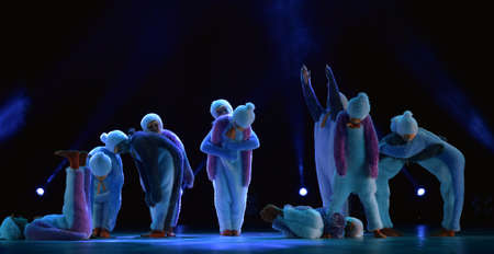 Children in a suit of penguins dance on a stage, Children's dance group, Petersburg, Russiaのeditorial素材