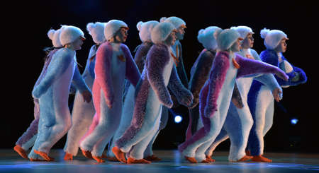 Children in a suit of penguins dance on a stage, Children's dance group, Petersburg, Russiaのeditorial素材