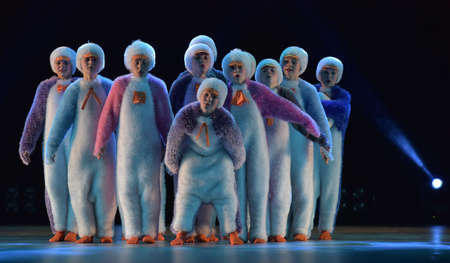 Children in a suit of penguins dance on a stage, Children's dance group, Petersburg, Russiaのeditorial素材