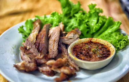 Grilled meat and sauce in a bowlの写真素材