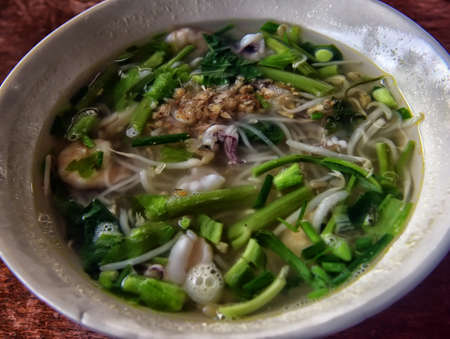 Soup with glass noodles and seafoodの写真素材