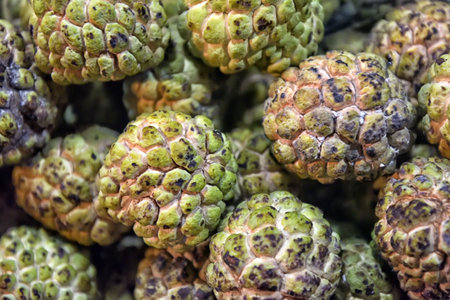 custard apple fruit, also known as sugar-apple or sweetsop. ripe custard apple on the market shelf...