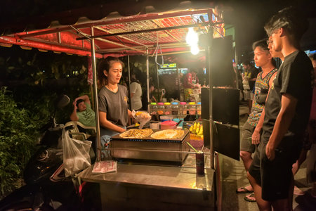 Koh Chang, Thailand -  05.07.2017  An unidentified Thai Man cooking Roti Mataba for sale traveller at street night market. Street cooking is a tradition and ubiquitous in Thailandのeditorial素材