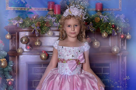 girl in white with a pink dress with flowers in her hair in christmasの写真素材