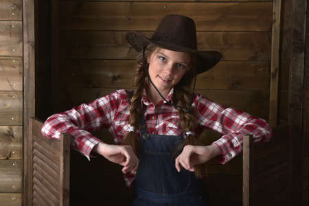 beautiful  girl in  plaid shirt and cowboy hat.の写真素材