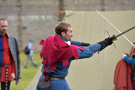 Russia, Ivangorod 01.08,2015 Festival of medieval reconstruction "Russian fortress", Fencing on swords in medieval costumesのeditorial素材